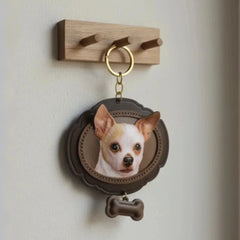 A personalized pet portrait leather keychain of a dog hanging from a modern wooden wall hook, showcasing its use as a home decor keepsake.