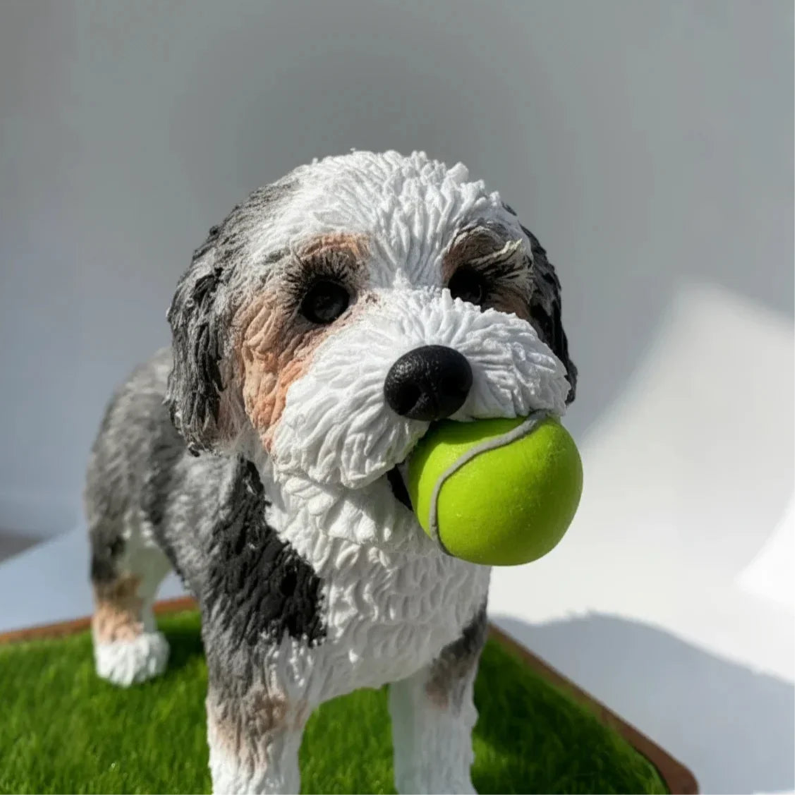 Close-up detail of the hand-sculpted fur texture and soulful eyes on a custom dog memorial statue.